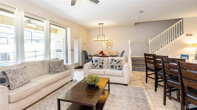 2030 Majorca Dr, Kissimmee, FL 34747 - living room with a ceiling fan, light tile patterned floors, stairway, and a chandelier