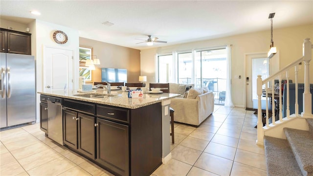 2030 Majorca Dr, Kissimmee, FL 34747 - kitchen with appliances with stainless steel finishes, a sink, open floor plan, a kitchen breakfast bar, and a ceiling fan