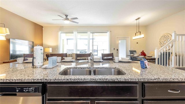 2030 Majorca Dr, Kissimmee, FL 34747 - kitchen featuring open floor plan, dishwasher, a sink, ceiling fan, and light stone counters