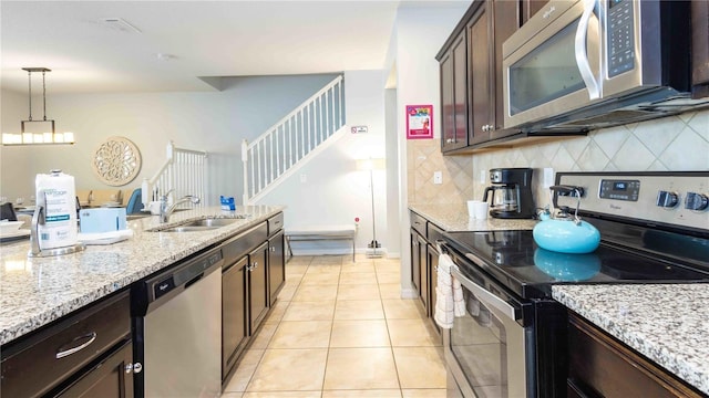 2030 Majorca Dr, Kissimmee, FL 34747 - kitchen featuring stainless steel appliances, a sink, backsplash, and pendant lighting