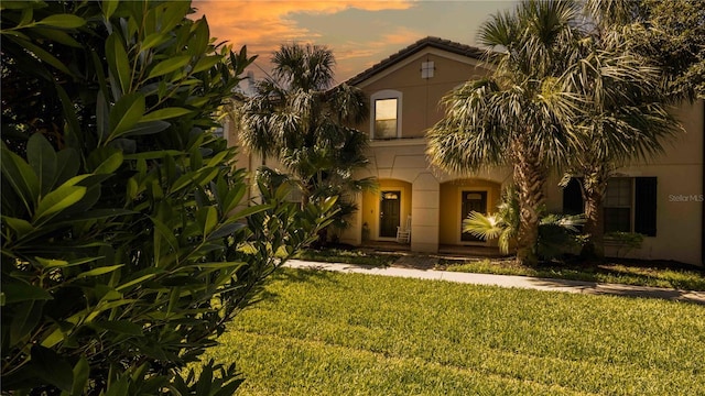 2030 Majorca Dr, Kissimmee, FL 34747 - mediterranean / spanish-style home featuring stucco siding and a lawn