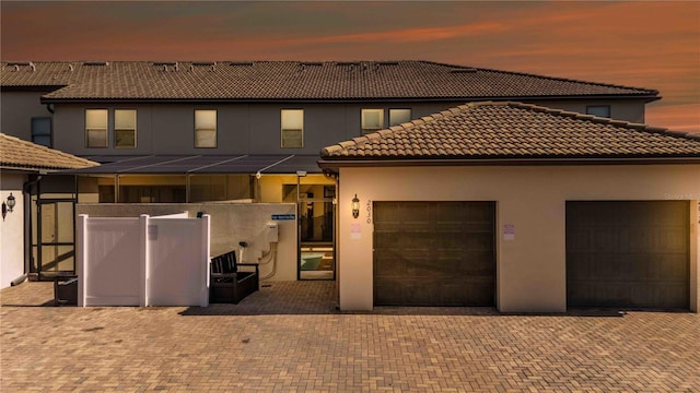 2030 Majorca Dr, Kissimmee, FL 34747 - view of front of house featuring stucco siding, a tiled roof, and a garage