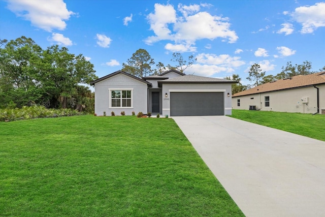 view of front of home with stucco siding, a garage, driveway, and a front yard