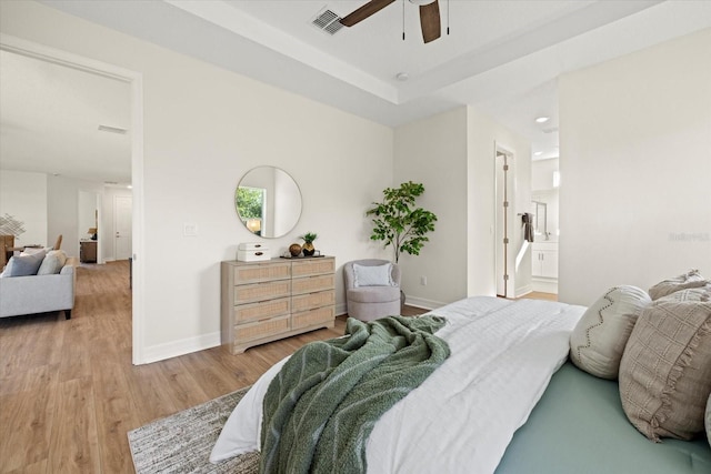 bedroom featuring baseboards, light wood-style floors, and ceiling fan