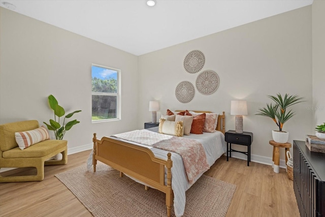 bedroom with baseboards, light wood-style floors, and recessed lighting