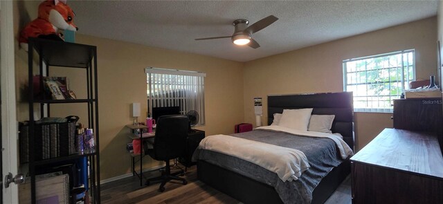 1302 Center St, Ocoee, FL 34761 - bedroom featuring wood finished floors, a textured ceiling, baseboards, ceiling fan, and an office area
