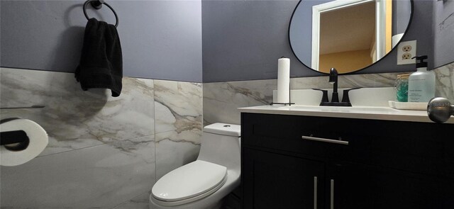 1302 Center St, Ocoee, FL 34761 - bathroom with tile walls, toilet, vanity, and wainscoting