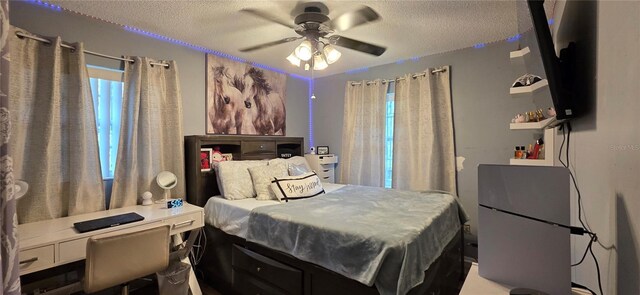 1302 Center St, Ocoee, FL 34761 - bedroom with a textured ceiling, ceiling fan, and a desk