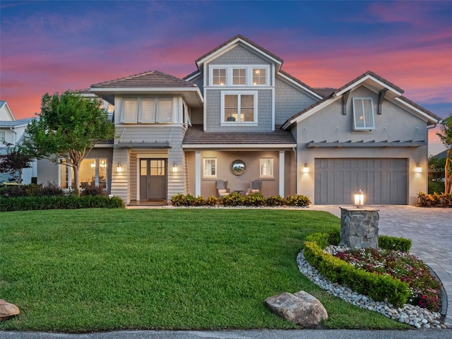 9916 Lone Tree Ln, Orlando, FL 32836 - view of front of home with decorative driveway, a lawn, stucco siding, and an attached garage