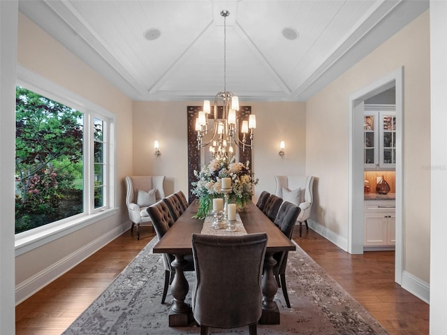 9916 Lone Tree Ln, Orlando, FL 32836 - dining space with a chandelier, wood finished floors, vaulted ceiling, and baseboards