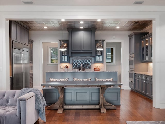 9916 Lone Tree Ln, Orlando, FL 32836 - kitchen featuring stainless steel appliances, crown molding, dark wood finished floors, glass insert cabinets, and open floor plan