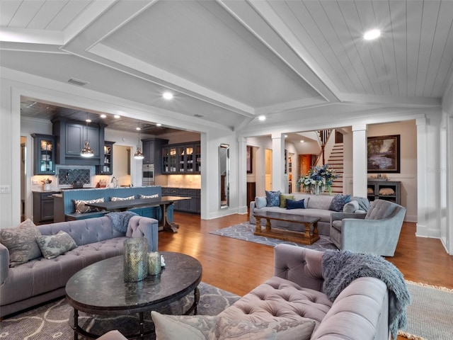 9916 Lone Tree Ln, Orlando, FL 32836 - living area with wood finished floors, vaulted ceiling, recessed lighting, bar area, and stairway