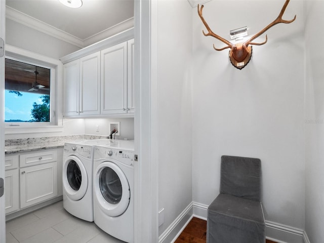 9916 Lone Tree Ln, Orlando, FL 32836 - washroom featuring cabinet space, washer and dryer, crown molding, and baseboards