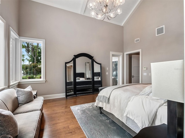 9916 Lone Tree Ln, Orlando, FL 32836 - bedroom with high vaulted ceiling, a chandelier, wood finished floors, and baseboards