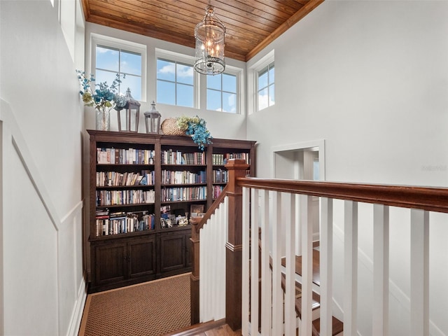 9916 Lone Tree Ln, Orlando, FL 32836 - stairs featuring wooden ceiling, crown molding, and a chandelier