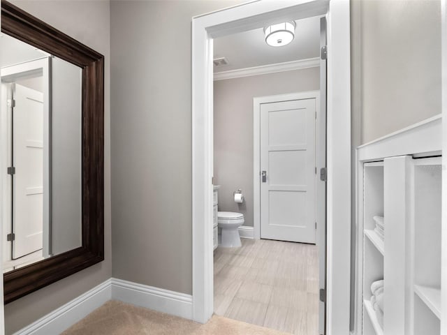 9916 Lone Tree Ln, Orlando, FL 32836 - bathroom with crown molding, baseboards, toilet, and tile patterned floors