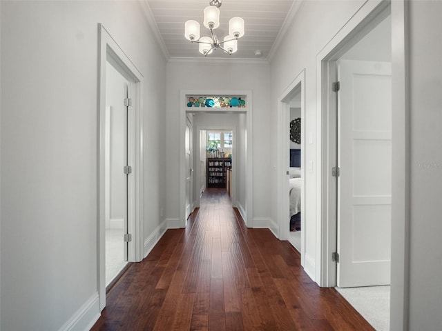9916 Lone Tree Ln, Orlando, FL 32836 - hallway with dark wood finished floors, a chandelier, ornamental molding, and baseboards