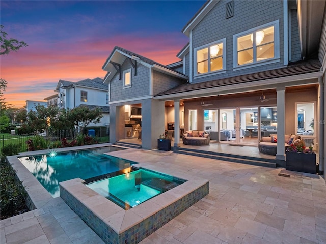 9916 Lone Tree Ln, Orlando, FL 32836 - back of property with an outdoor living space with a fireplace, a patio, a pool with connected hot tub, and a ceiling fan