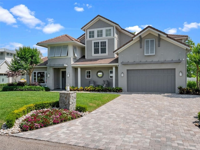 9916 Lone Tree Ln, Orlando, FL 32836 - view of front of house featuring driveway, a front lawn, stucco siding, and a garage