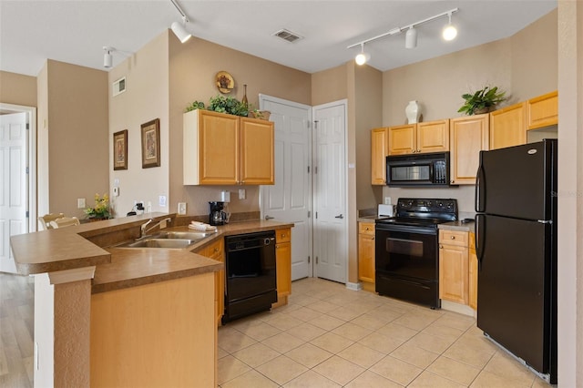 kitchen with black appliances, rail lighting, a sink, a peninsula, and light brown cabinetry