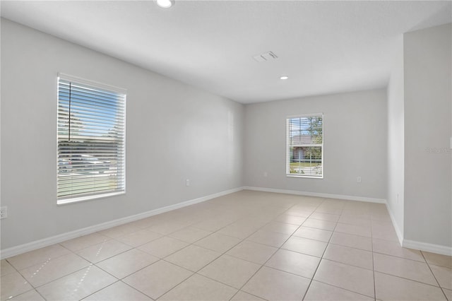 1119 Union Ave, Mascotte, FL 34753 - spare room featuring recessed lighting, light tile patterned floors, and baseboards