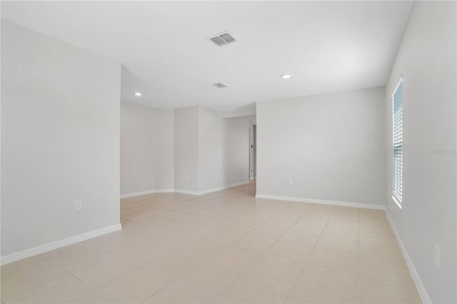 1119 Union Ave, Mascotte, FL 34753 - spare room featuring healthy amount of natural light, recessed lighting, baseboards, and light tile patterned flooring
