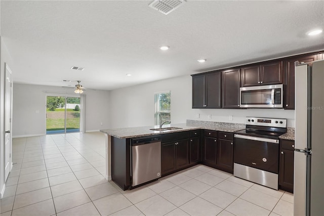 1119 Union Ave, Mascotte, FL 34753 - kitchen with stainless steel appliances, ceiling fan, a sink, light stone countertops, and recessed lighting