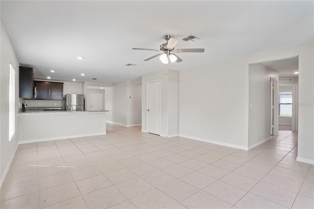 1119 Union Ave, Mascotte, FL 34753 - unfurnished living room featuring ceiling fan, light tile patterned floors, baseboards, and recessed lighting