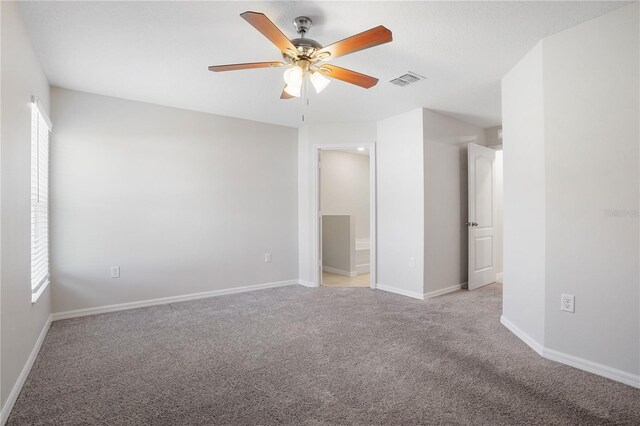 1119 Union Ave, Mascotte, FL 34753 - unfurnished bedroom with multiple windows, light carpet, and baseboards