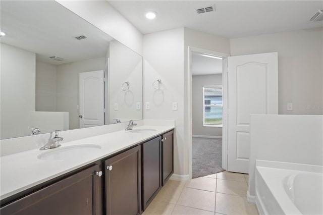 1119 Union Ave, Mascotte, FL 34753 - full bath featuring tile patterned floors, double vanity, a garden tub, baseboards, and recessed lighting