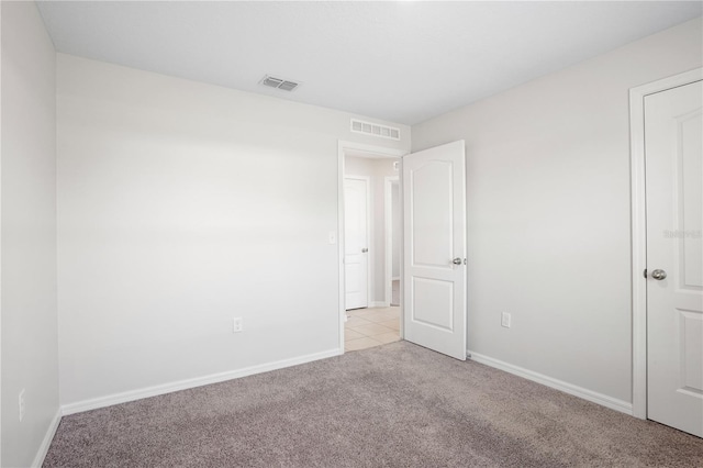 1119 Union Ave, Mascotte, FL 34753 - unfurnished bedroom featuring light colored carpet and baseboards