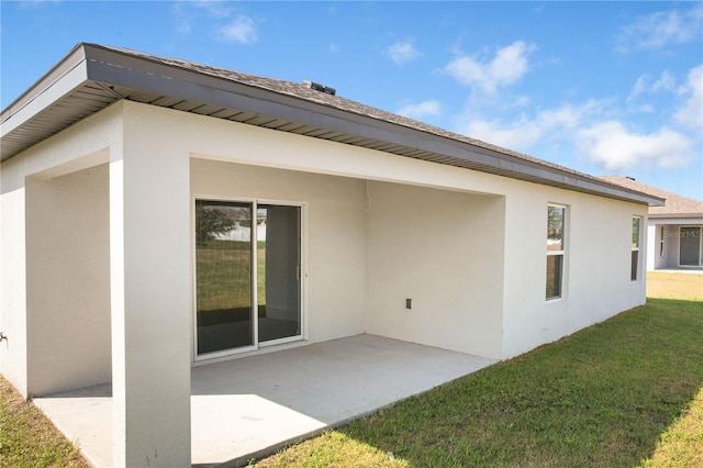 1119 Union Ave, Mascotte, FL 34753 - back of house with stucco siding, a patio area, and a yard