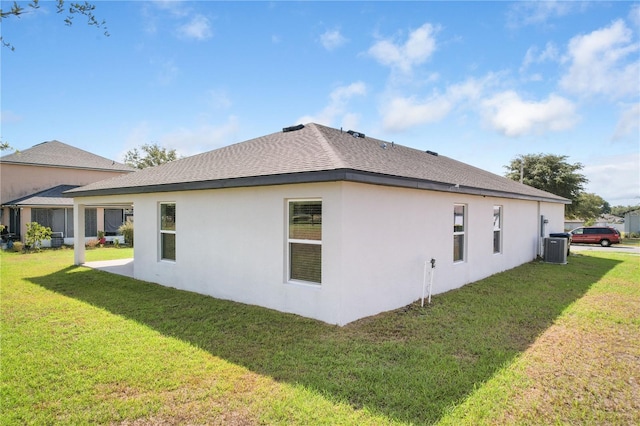 1119 Union Ave, Mascotte, FL 34753 - view of side of property featuring a yard, stucco siding, and roof with shingles