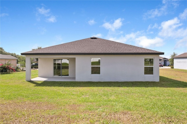 1119 Union Ave, Mascotte, FL 34753 - rear view of house featuring roof with shingles, stucco siding, a lawn, and a patio area