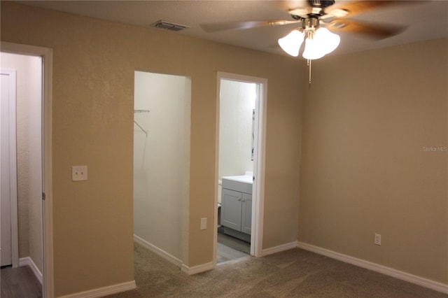 unfurnished room featuring ceiling fan, carpet, and baseboards