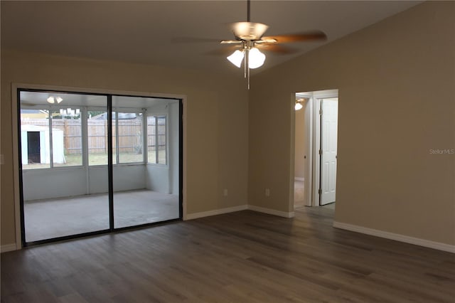 empty room featuring wood finished floors, a ceiling fan, baseboards, and vaulted ceiling