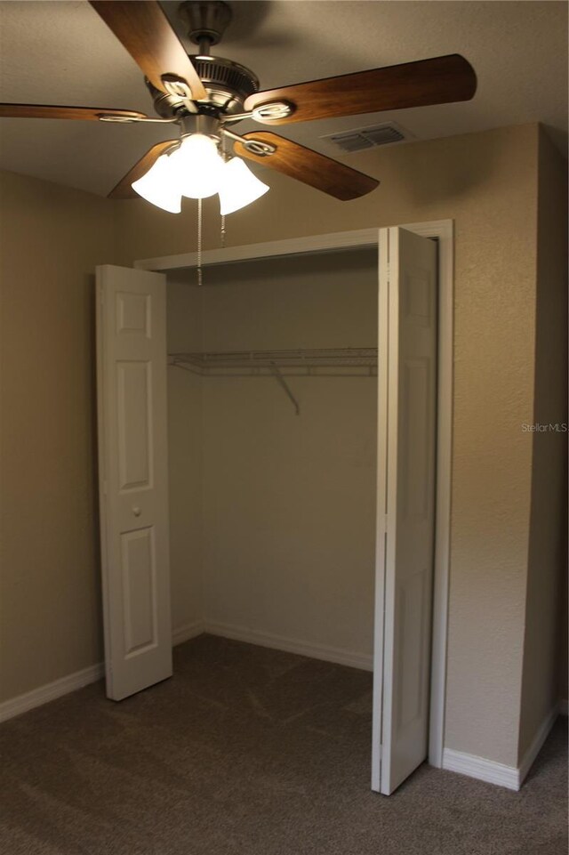 unfurnished bedroom with carpet floors, a closet, ceiling fan, and baseboards