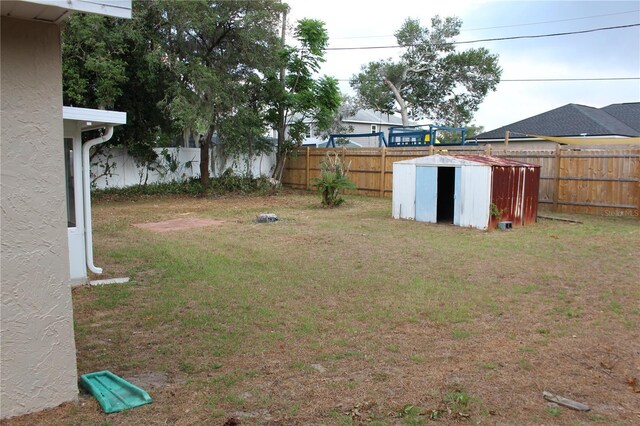 view of yard featuring a shed and an outbuilding