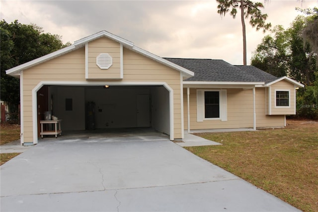 ranch-style house with an attached garage, concrete driveway, and a front yard