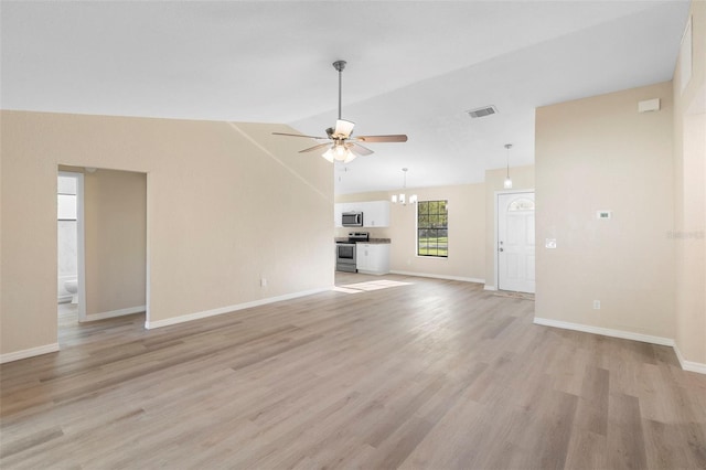 1550 Maxwell Ln, Deltona, FL 32738 - unfurnished living room featuring ceiling fan, a chandelier, lofted ceiling, light wood-style floors, and baseboards