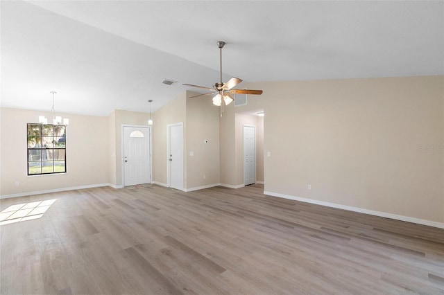 1550 Maxwell Ln, Deltona, FL 32738 - unfurnished living room featuring a chandelier, vaulted ceiling, light wood finished floors, and a ceiling fan