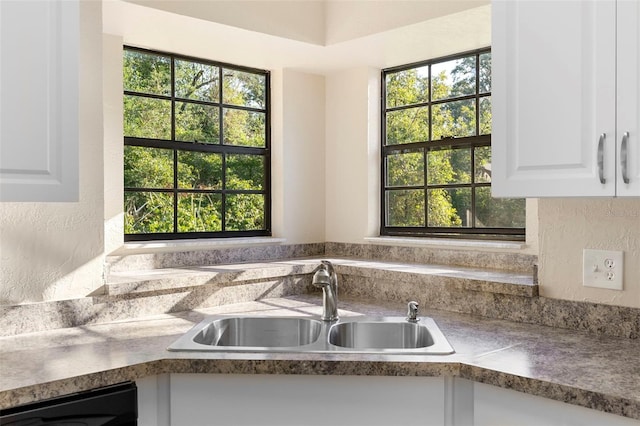 1550 Maxwell Ln, Deltona, FL 32738 - kitchen with a sink, dishwashing machine, white cabinets, and dark countertops