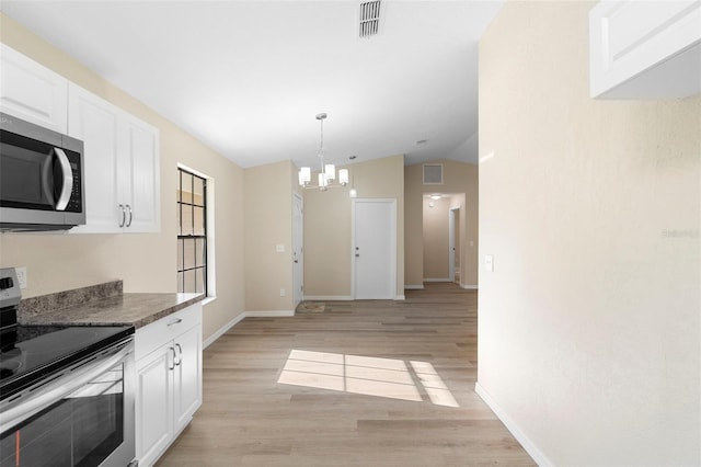 1550 Maxwell Ln, Deltona, FL 32738 - kitchen featuring stainless steel appliances, lofted ceiling, a chandelier, light wood-style floors, and white cabinets