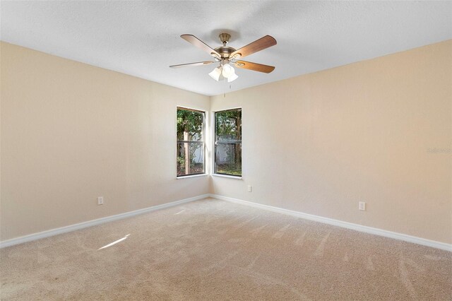 1550 Maxwell Ln, Deltona, FL 32738 - spare room with light carpet, baseboards, a ceiling fan, and a textured ceiling
