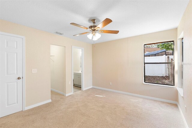 1550 Maxwell Ln, Deltona, FL 32738 - unfurnished bedroom featuring light colored carpet, baseboards, and ensuite bath