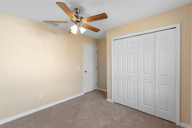 1550 Maxwell Ln, Deltona, FL 32738 - unfurnished bedroom featuring carpet flooring, baseboards, a closet, and a ceiling fan