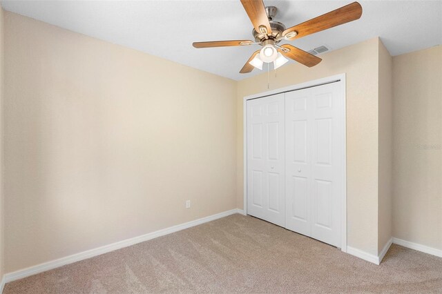 1550 Maxwell Ln, Deltona, FL 32738 - unfurnished bedroom featuring light carpet, baseboards, a closet, and a ceiling fan