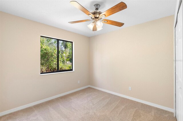 1550 Maxwell Ln, Deltona, FL 32738 - spare room featuring light colored carpet, ceiling fan, and baseboards