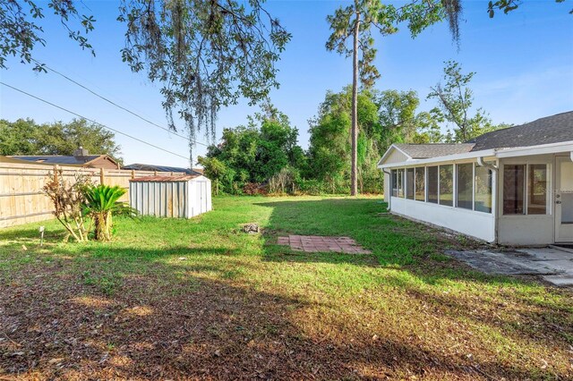 1550 Maxwell Ln, Deltona, FL 32738 - view of yard with a sunroom, a storage unit, and an outdoor structure