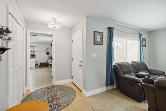 entryway featuring light tile patterned flooring and baseboards